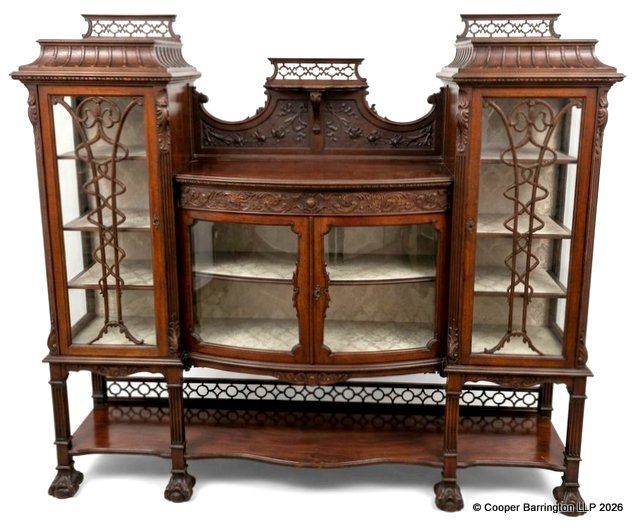 A Fine Art Nouveau Mahogany Salon Cabinet Display. Early 1900.  In the style of Gillows having twin pagoda tops with fretted upstands below are twin doors with art nouveau stylized moldings opening to reveal triple shelves,the interiour lined with the original brocade lining. To the centre a bow fronted two door cabinet with carved and fretted upstand ,molded top over two doors enclosing a single shelf again lined in the original brocade. All raised on reeded legs linked with a shaped undershelf with matching pierced upstand and carved paw feet. Height 59.5 in, Width 66 in, Depth 16 inches.