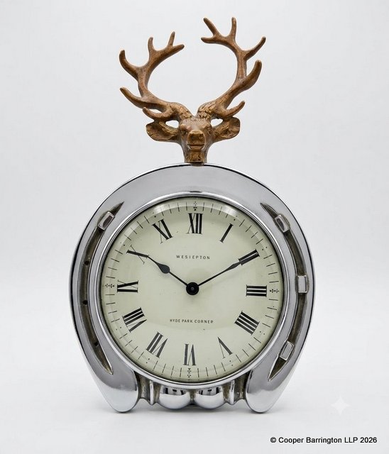 Vintage Wesiepton  Hyde Park Corner London Horseshoe and Cast Metal Stag Desk Clock in Silver-Tone Case.  Mid 20th Century.  The white  enamel dial with Roman numerals behind a bevelled glass running on a platform movement.  Working order with key.