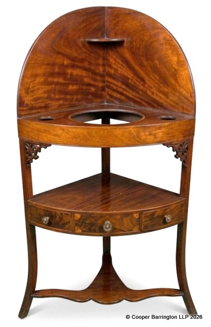 Antique Georgian Mahogany Corner Washstand. Late 18th / Early 19th Century. Having a shaped splashback gallery with a small top corner shelf a cut out basin tier with soap or accessory holes and a lower tier with a small drawer. A later shelf has been made to cover the cut out tier if not rerquired. Height 47 In, Width 25 in, Depth 18 inches.