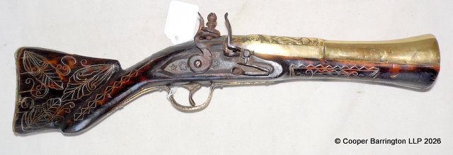 A 19th-century Ottoman-influenced Balkan trade flintlock blunderbuss pistol. Features a characteristic two-stage, stepped brass barrel terminating in a prominent, flared funnel-shaped blunderbuss muzzle. The breech section displays hand-chiseled geometric borders and traditional engraving. Fitted with a robust, hand-forged iron flintlock mechanism. The flat lock plate is distinctly hand-stamped with traditional regional five-pointed star symbols. The mechanism is in fully functional condition.Full-length dark wood stock adorned with extensive, intact brass wire leaf-and-tendril wirework inlay. Lenth 42 cm. A 19th-century Ottoman-influenced Balkan trade flintlock blunderbuss pistol. Features a characteristic two-stage, stepped brass barrel terminating in a prominent, flared funnel-shaped blunderbuss muzzle. The breech section displays hand-chiseled geometric borders and traditional engraving. Fitted with a robust, hand-forged iron flintlock mechanism. The flat lock plate is distinctly hand-stamped with traditional regional five-pointed star symbols. The mechanism is in fully functional condition.Full-length dark wood stock adorned with extensive, intact brass wire leaf-and-tendril wirework inlay. Lenth 42 cm.